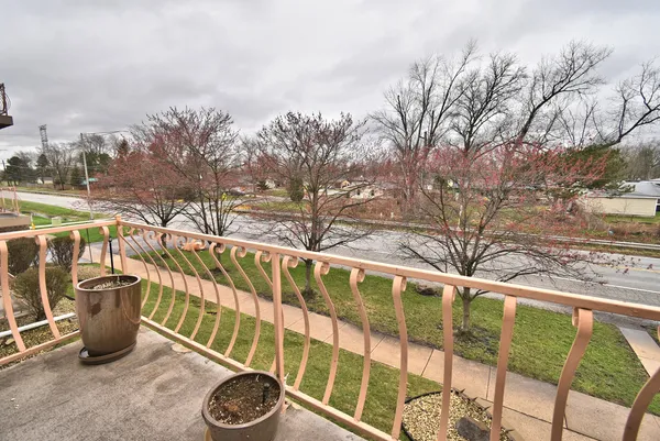 a view of a chairs and table in the balcony