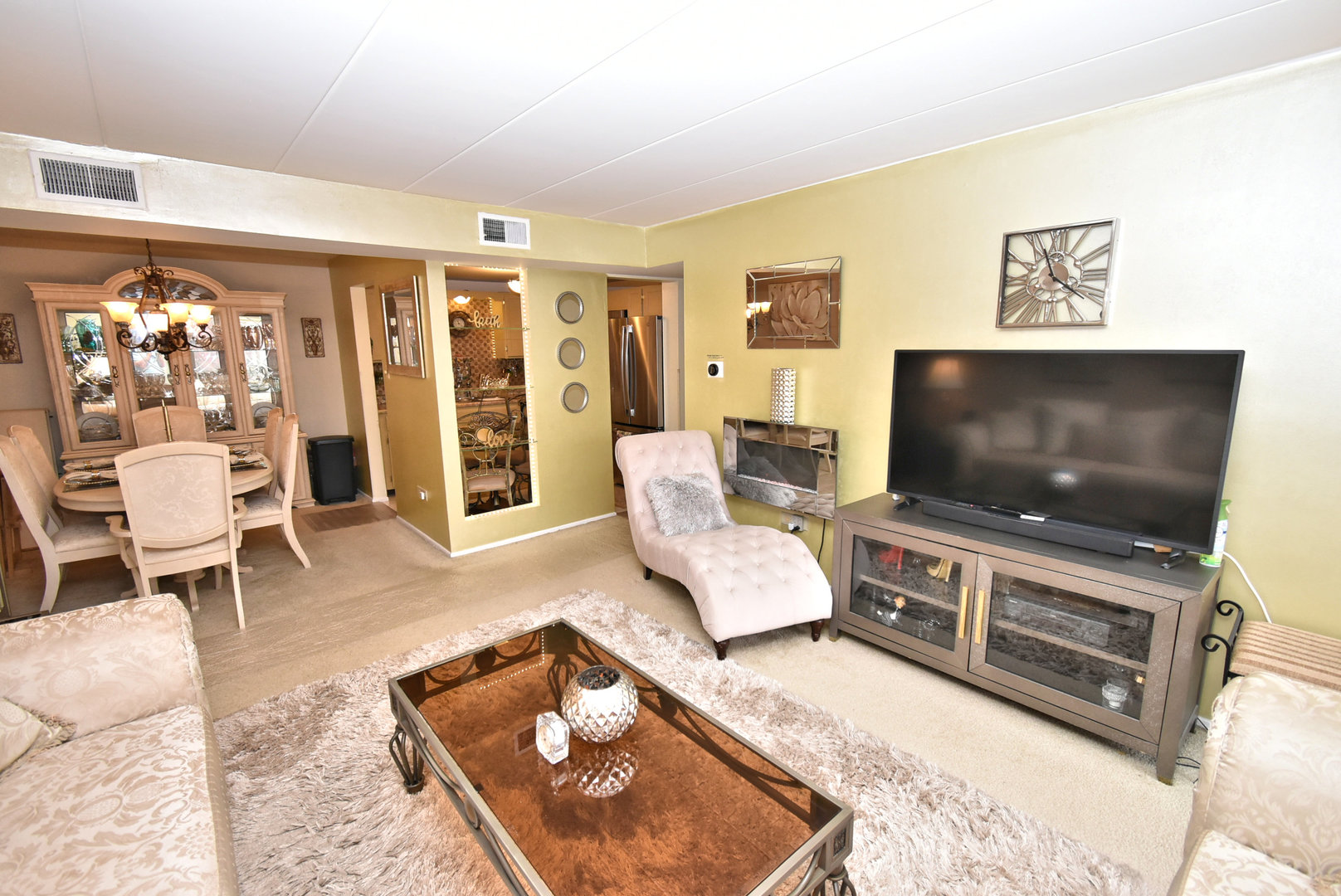 18855 Burnham Avenue, Unit 234 Lansing, IL 60438 - Photo 2 of 25 a living room with furniture and a flat screen tv