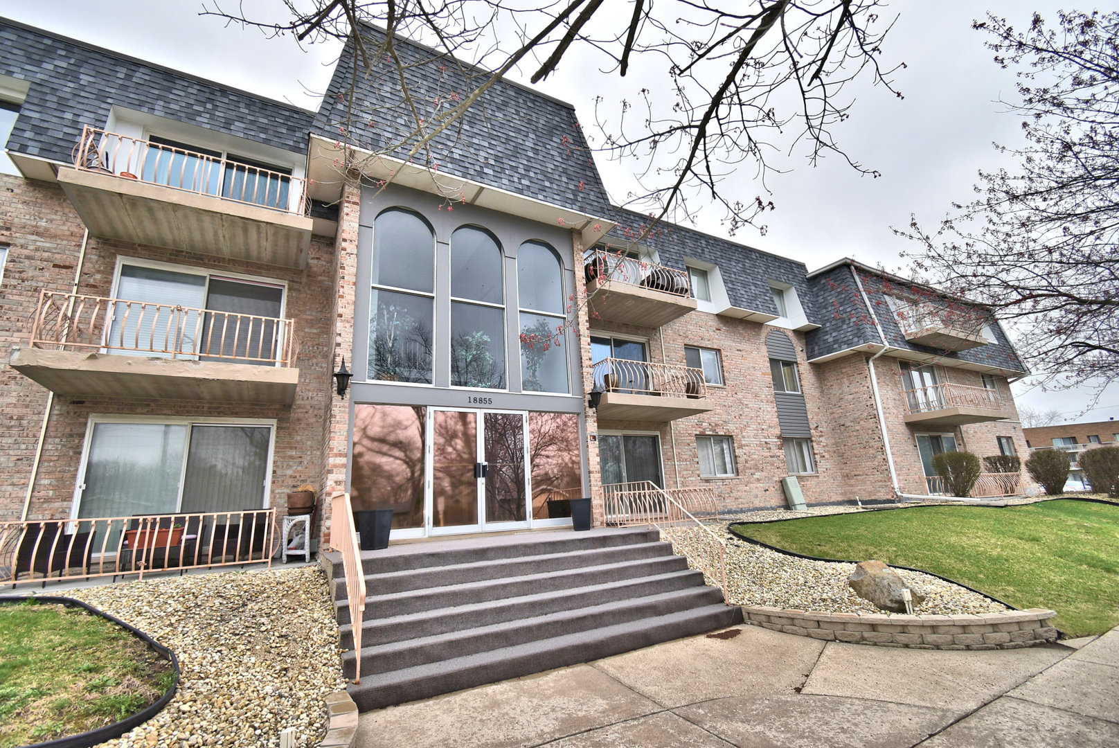 18855 Burnham Avenue, Unit 234 Lansing, IL 60438 - Photo 23 of 25 a view of a building with a yard