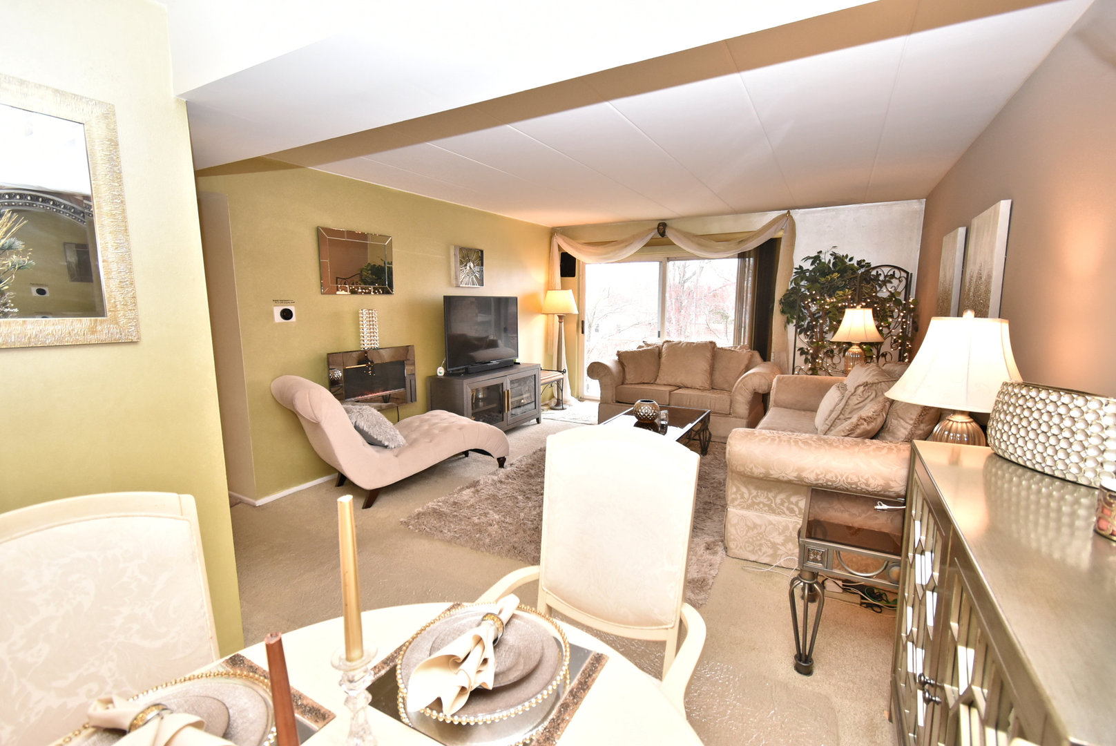 18855 Burnham Avenue, Unit 234 Lansing, IL 60438 - Photo 7 of 25 a living room with furniture and a flat screen tv