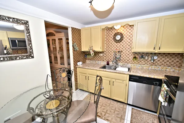 a kitchen with stainless steel appliances granite countertop a sink and cabinets