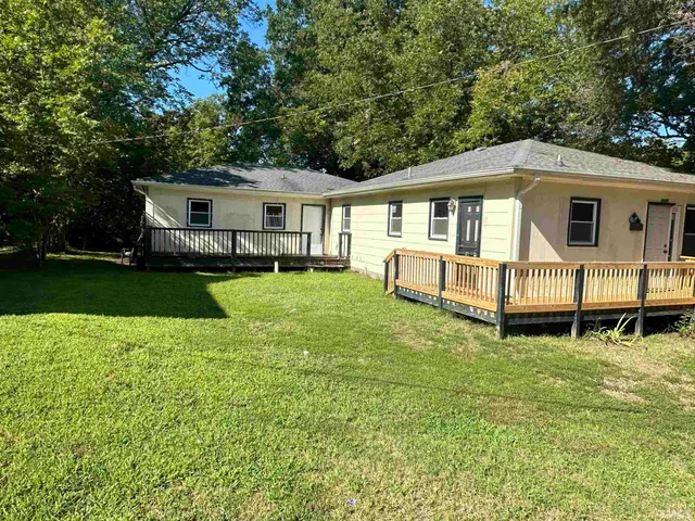 a view of a house with a backyard