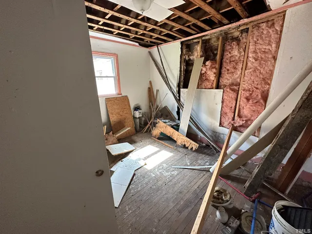 a water heater on a wooden floor