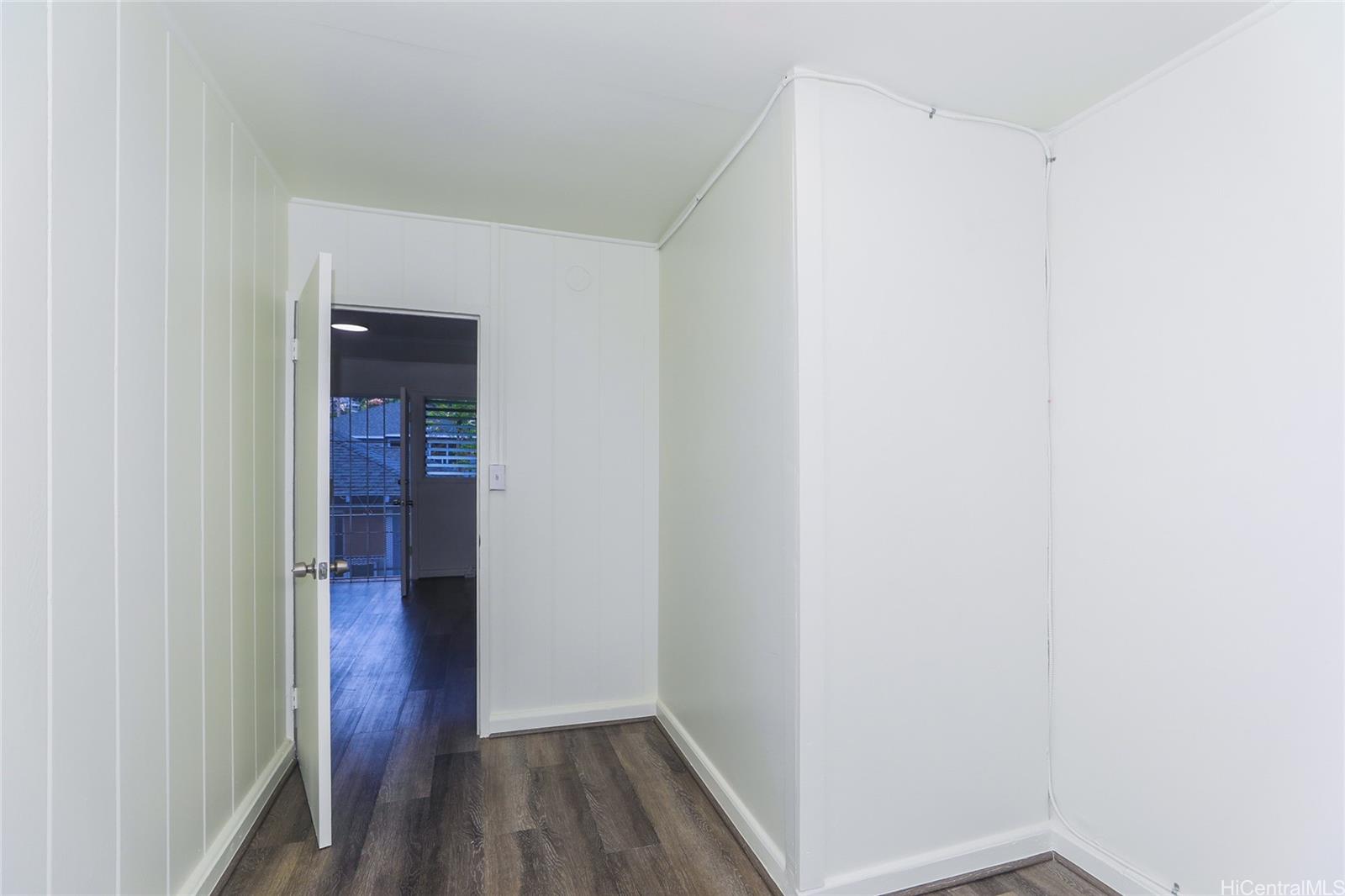 1719 Nuuanu Avenue, Unit 5E Honolulu, HI 96817 - Photo 19 of 25 a view of a hallway with wooden floor