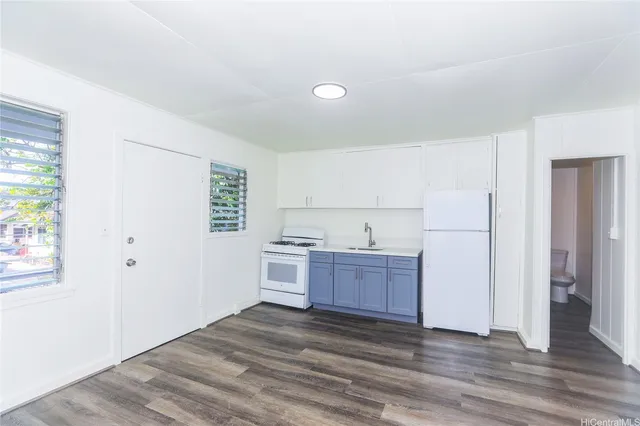 a kitchen with stainless steel appliances granite countertop a refrigerator sink and cabinets