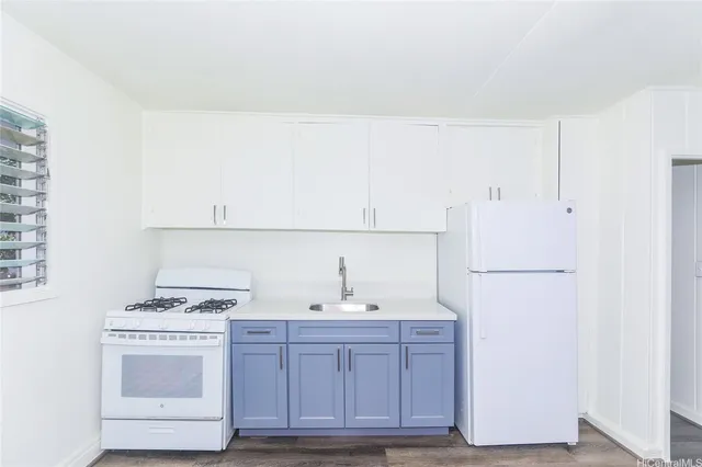 a kitchen with a sink cabinets and appliances