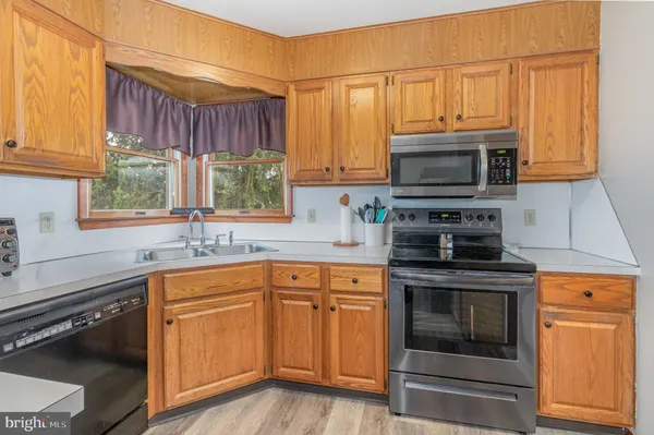 a kitchen with a sink stove and microwave