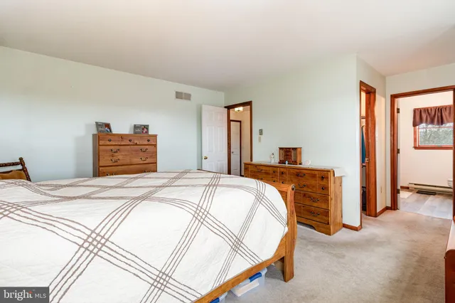 a bedroom with a bed and a dresser