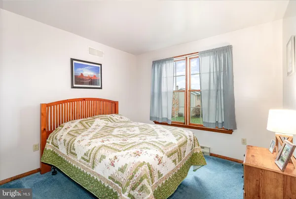 a bed sitting in a bedroom next to a window