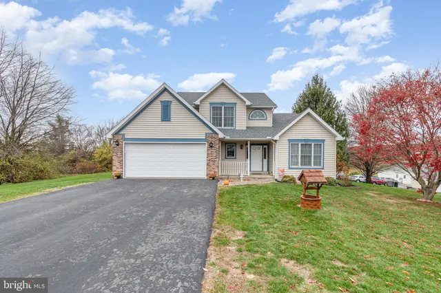 a front view of house with yard and green space