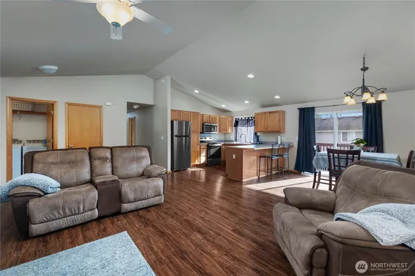 a living room with furniture and kitchen view