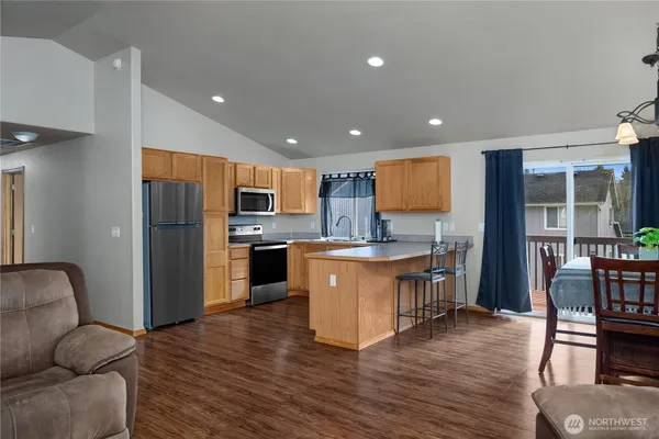 a kitchen with stainless steel appliances granite countertop a refrigerator and a stove top oven