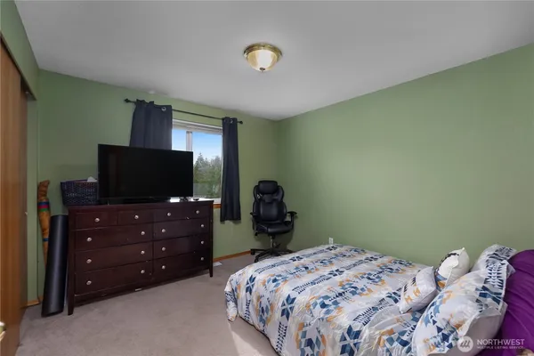 a bedroom with a bed and a television