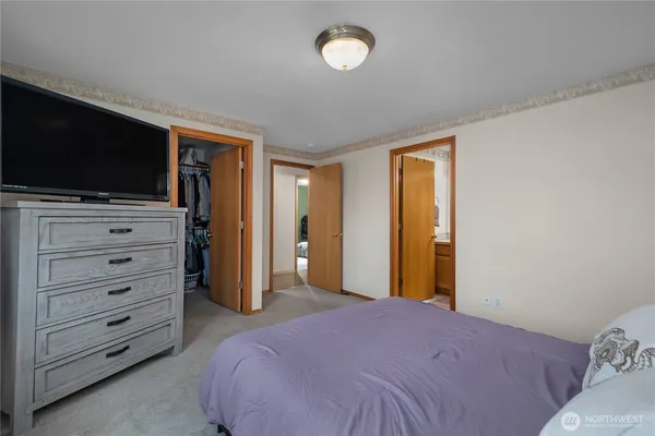a bedroom with a bed and flat screen tv