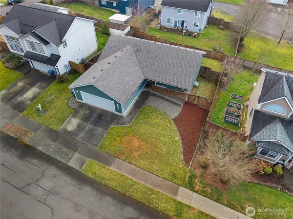 an aerial view of a house with garden space and street view