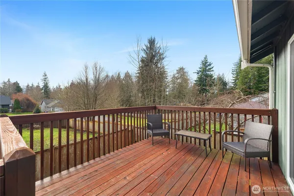 a view of balcony with wooden floor and fence