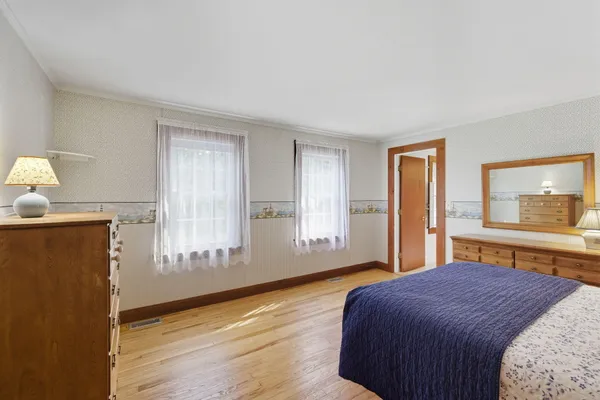 a spacious bedroom with a bed and a window