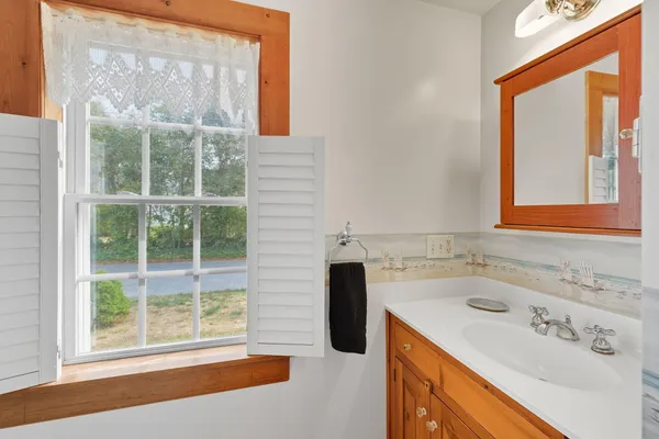 a bathroom with a sink and a window
