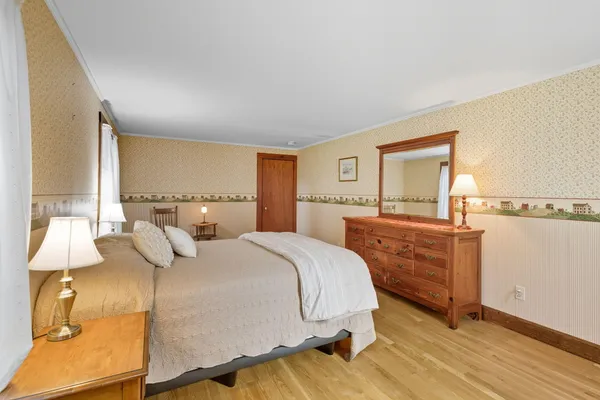 a bedroom with a bed and a dresser