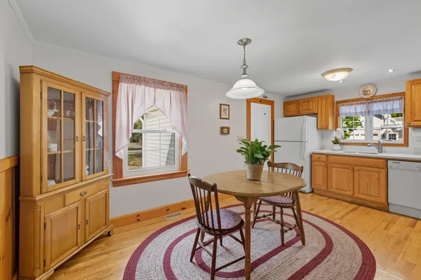 a view of a dining room with furniture window and wooden floor