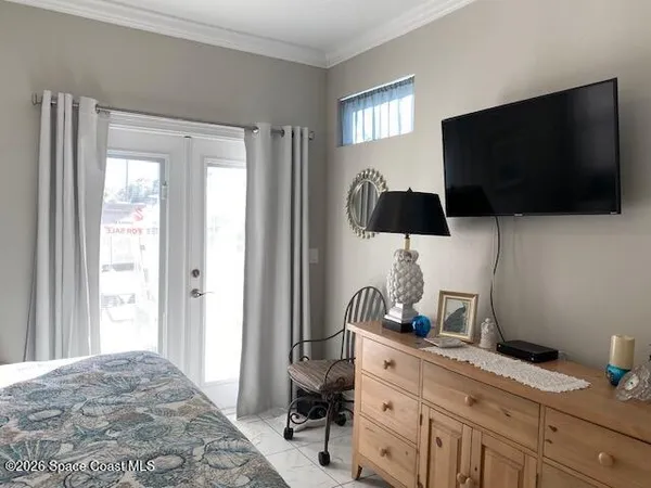 a bedroom with a bed and flat screen tv
