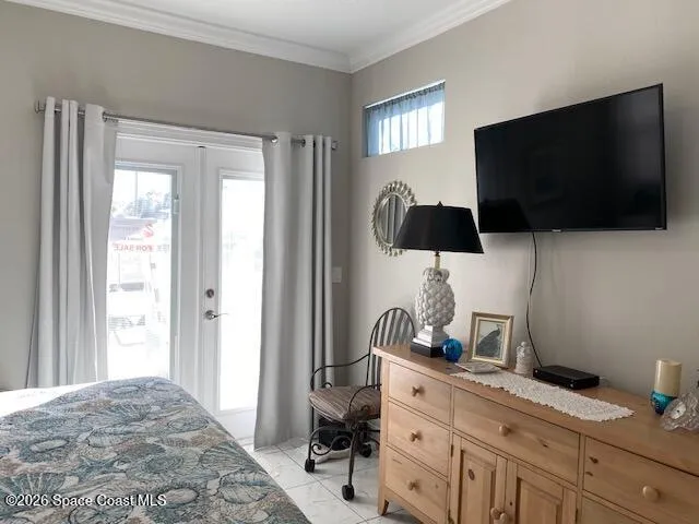a bedroom with a bed and flat screen tv