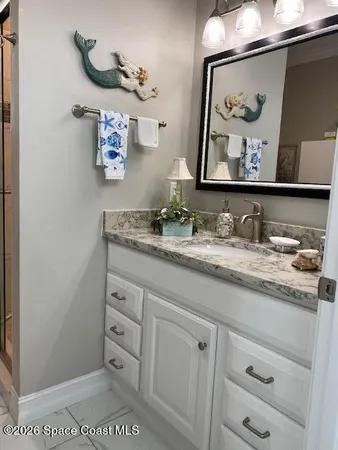 a bathroom with a sink mirror and vanity
