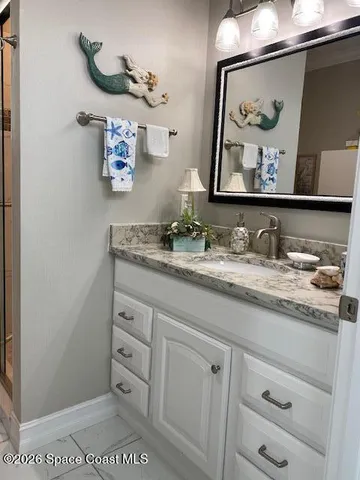 a bathroom with a sink mirror and vanity