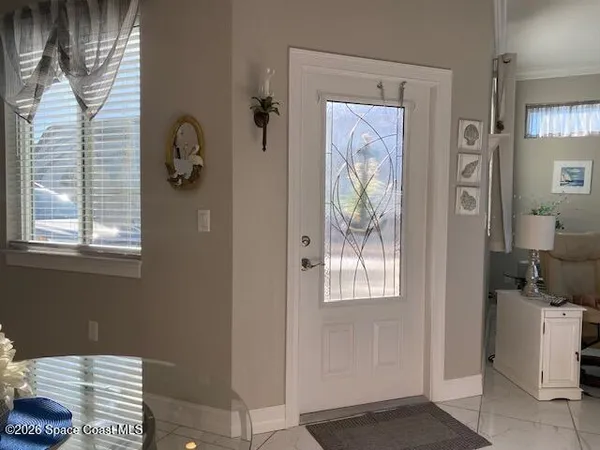 a bathroom with a window and a mirror