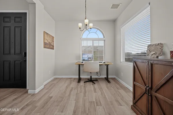 a workspace with wooden floor and windows