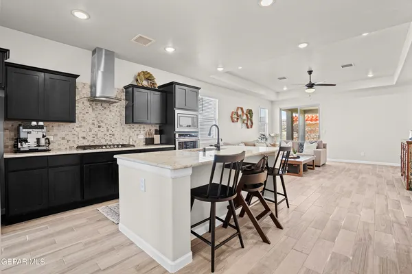 a kitchen with stainless steel appliances kitchen island granite countertop a sink and cabinets