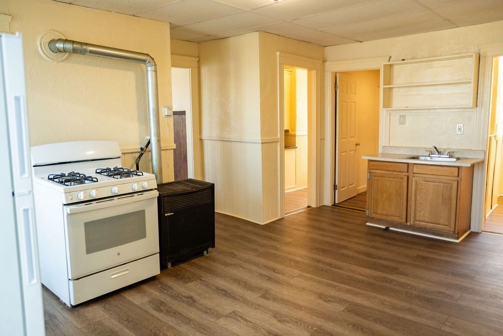 42 Dorcester, Unit 3 Worcester, MA 01604 - Photo 13 of 29 a kitchen with stainless steel appliances granite countertop a stove and a refrigerator