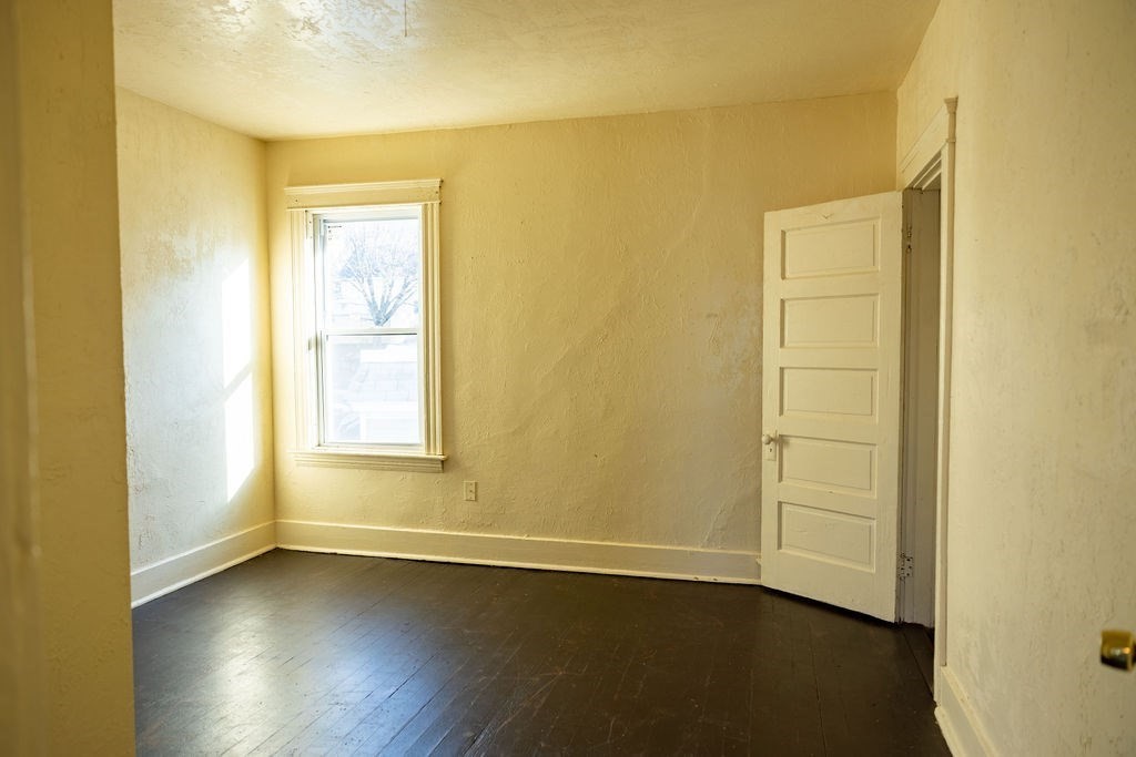 42 Dorcester, Unit 3 Worcester, MA 01604 - Photo 9 of 29 a view of an empty room with wooden floor and a window