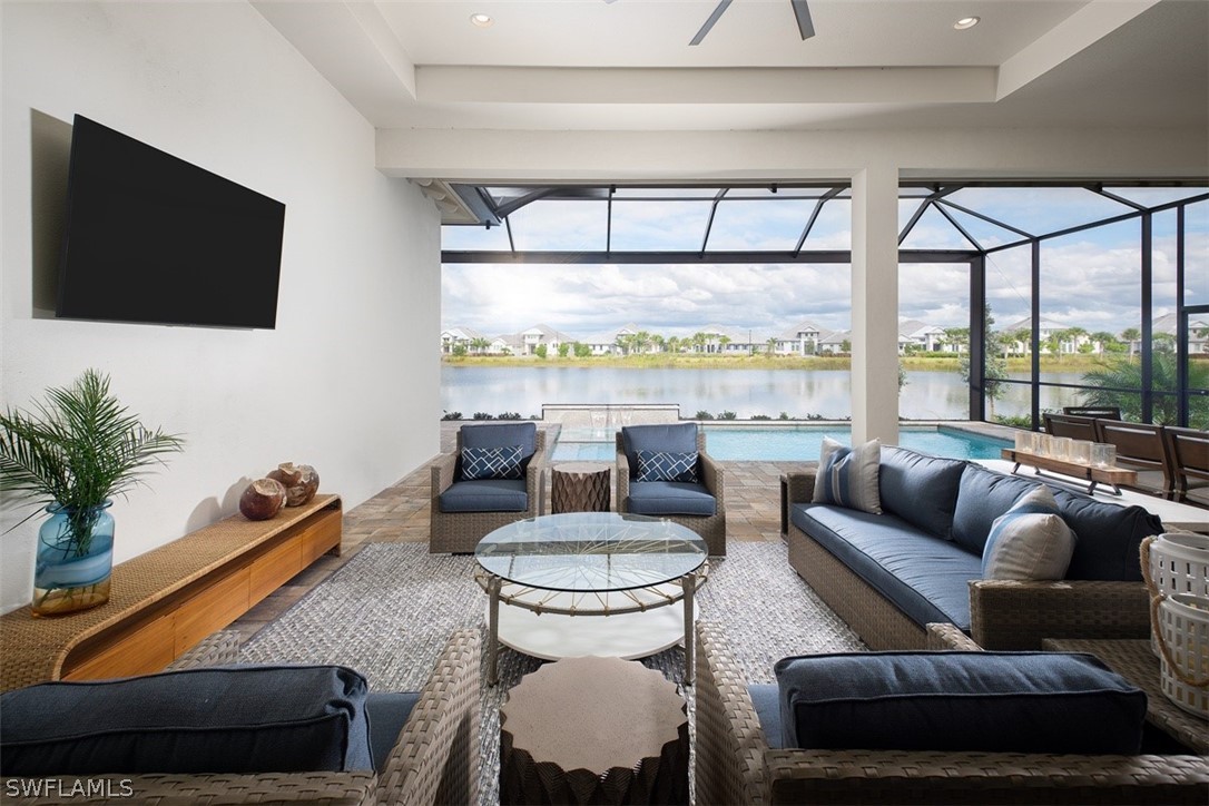 6181 Megans Bay Drive Naples, FL 34113 - Photo 16 of 32 a living room with furniture a flat screen tv and a large window