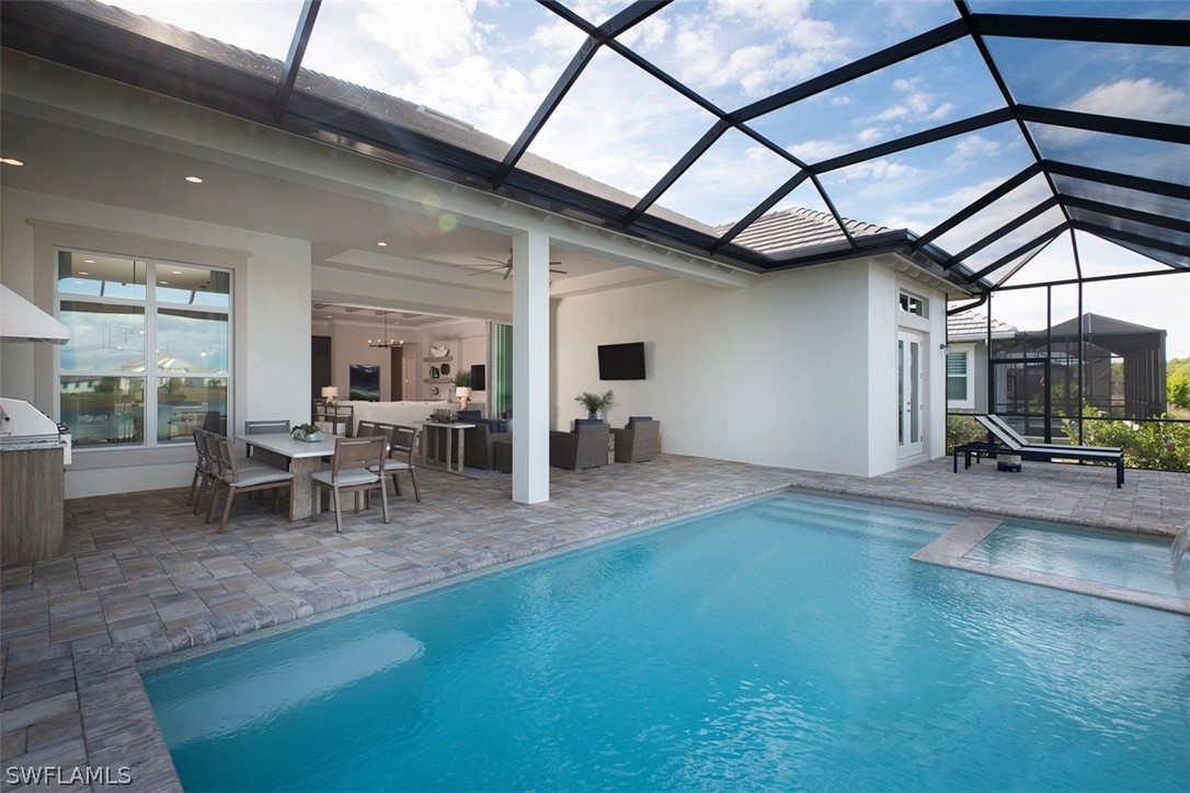 6181 Megans Bay Drive Naples, FL 34113 - Photo 20 of 32 a view of a livingroom with furniture and a table