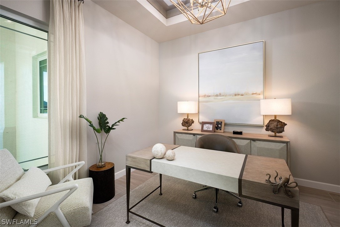 6181 Megans Bay Drive Naples, FL 34113 - Photo 22 of 32 a living room with furniture and a potted plant