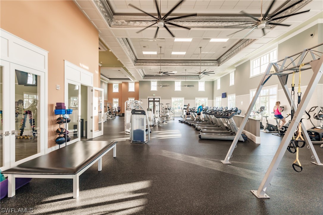 6181 Megans Bay Drive Naples, FL 34113 - Photo 28 of 32 a gym room with lots of furniture and lots of gym equipment