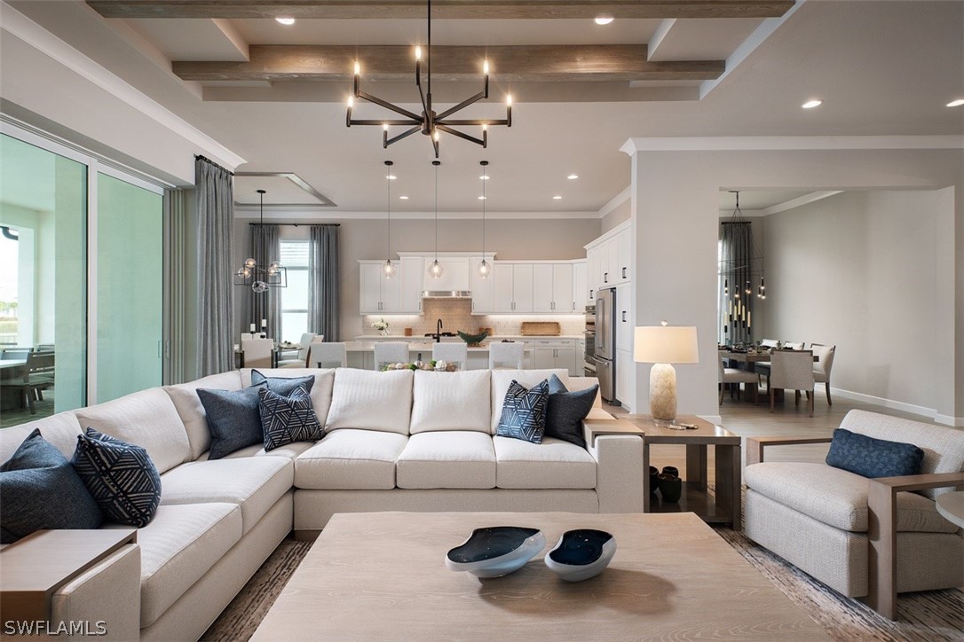 6181 Megans Bay Drive Naples, FL 34113 - Photo 4 of 32 a living room with furniture and a chandelier