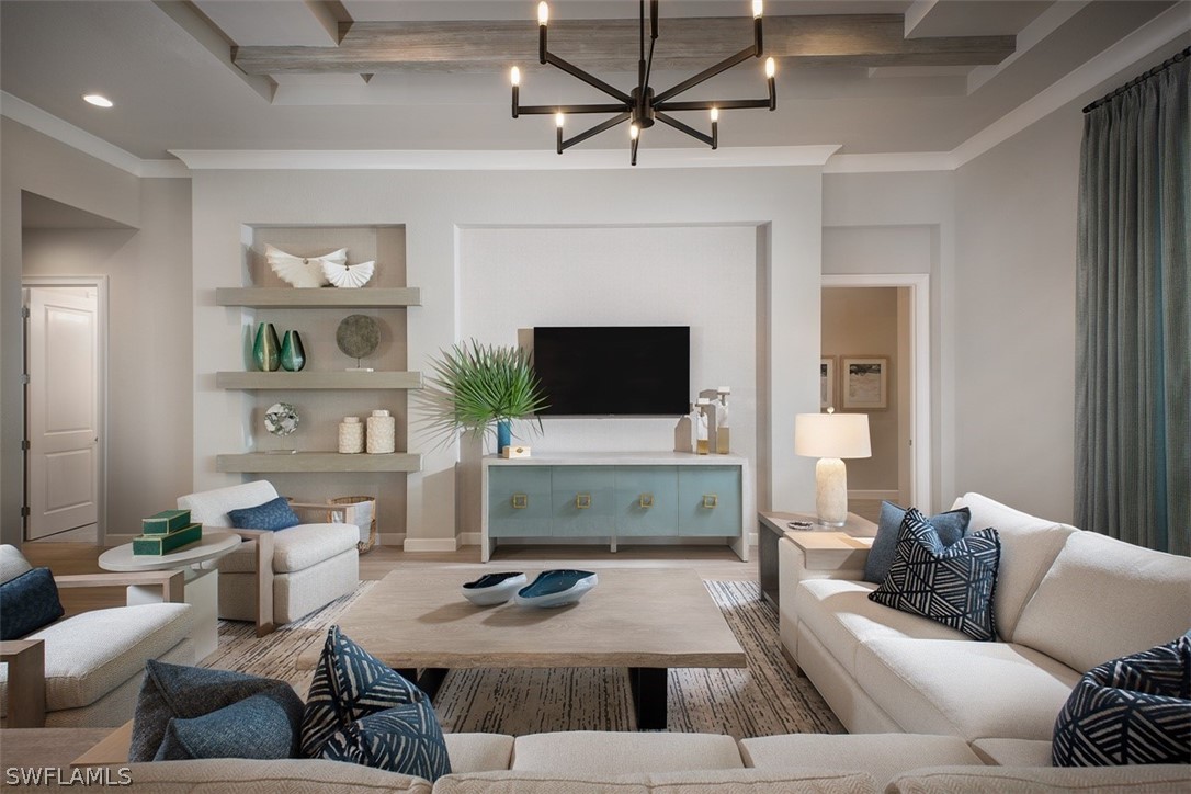 6181 Megans Bay Drive Naples, FL 34113 - Photo 6 of 32 a living room with furniture a flat screen tv and a fireplace