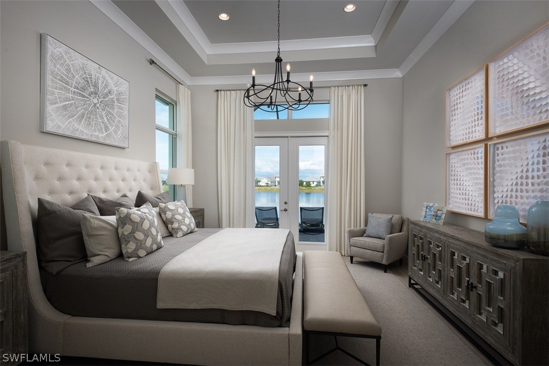 6181 Megans Bay Drive Naples, FL 34113 - Photo 7 of 32 a bedroom with bed or furniture and a chandelier