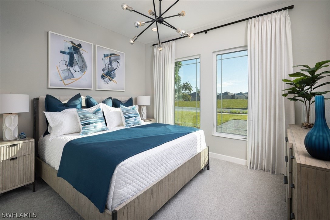 6181 Megans Bay Drive Naples, FL 34113 - Photo 9 of 32 a spacious bedroom with a bed and a window