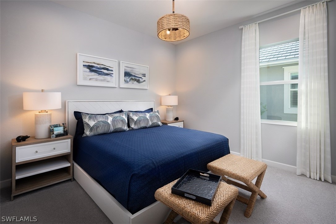 6181 Megans Bay Drive Naples, FL 34113 - Photo 10 of 32 a bedroom with a bed and a window