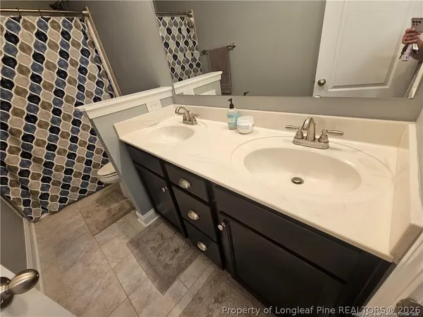 a bathroom with a double vanity sink and mirror