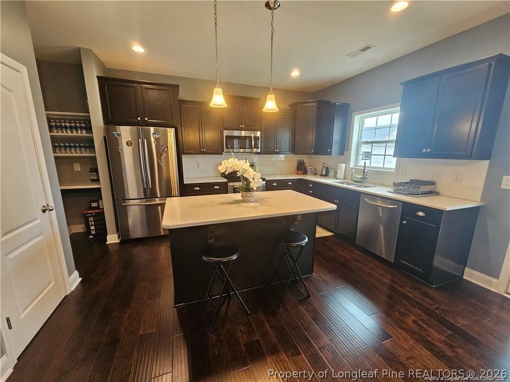 181 Pendleton Street Raeford, NC 28376 - Photo 5 of 19 a kitchen with stainless steel appliances granite countertop a sink refrigerator and cabinets