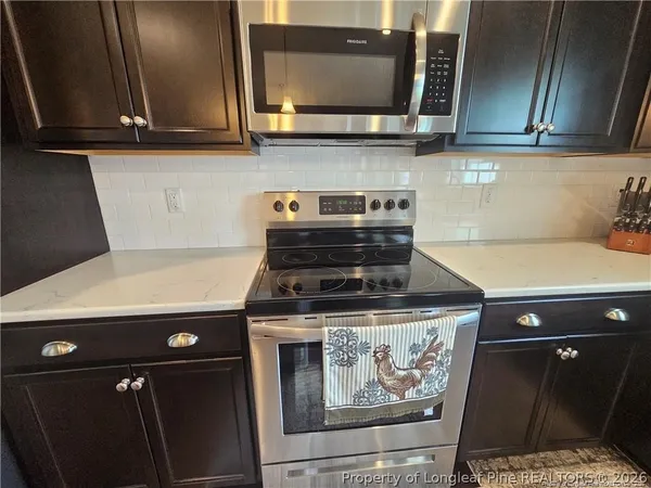 a stove top oven sitting inside of a kitchen