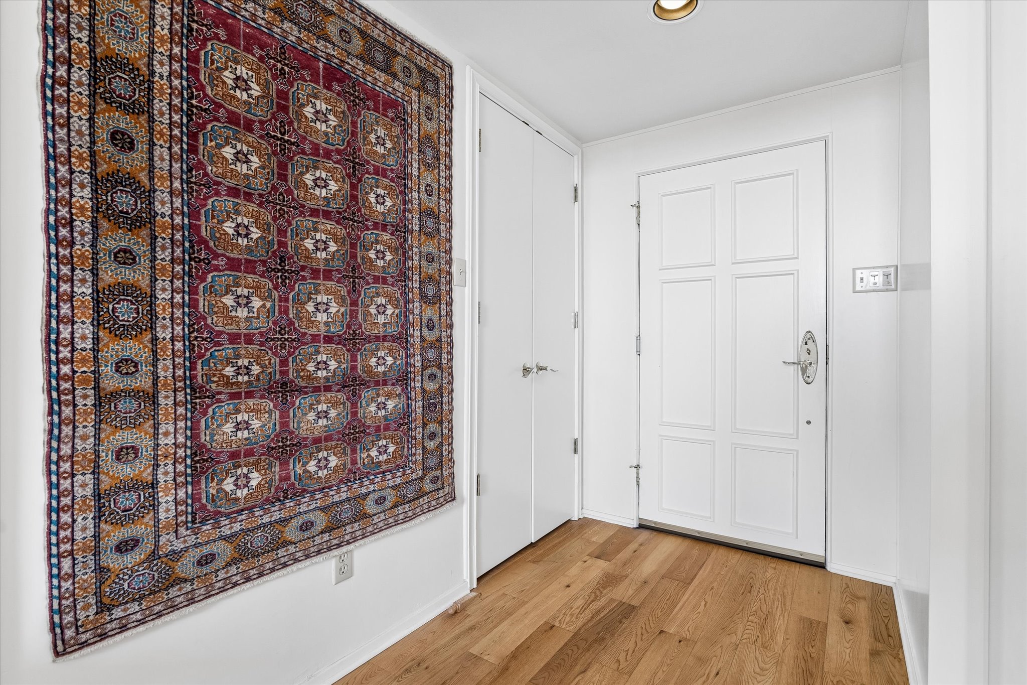 1801 Lavaca Street, Unit 3M Austin, TX 78701 - Photo 13 of 30 Hall with light wood-style floors and baseboards