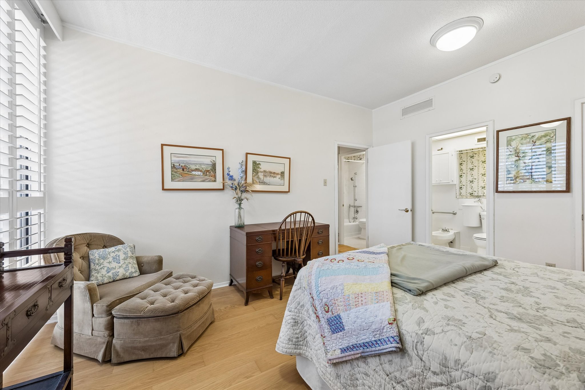 1801 Lavaca Street, Unit 3M Austin, TX 78701 - Photo 8 of 30 Bedroom featuring light wood-style flooring and ensuite bath