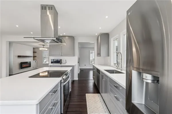 a kitchen with stainless steel appliances granite countertop a sink a stove and a refrigerator