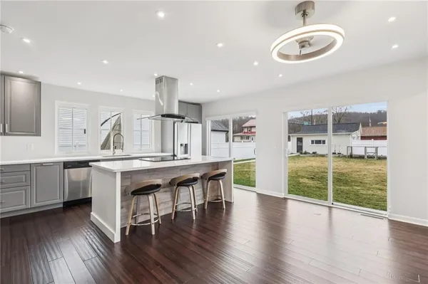 a large kitchen with a table and chairs