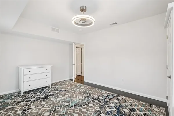 an empty room with a dresser